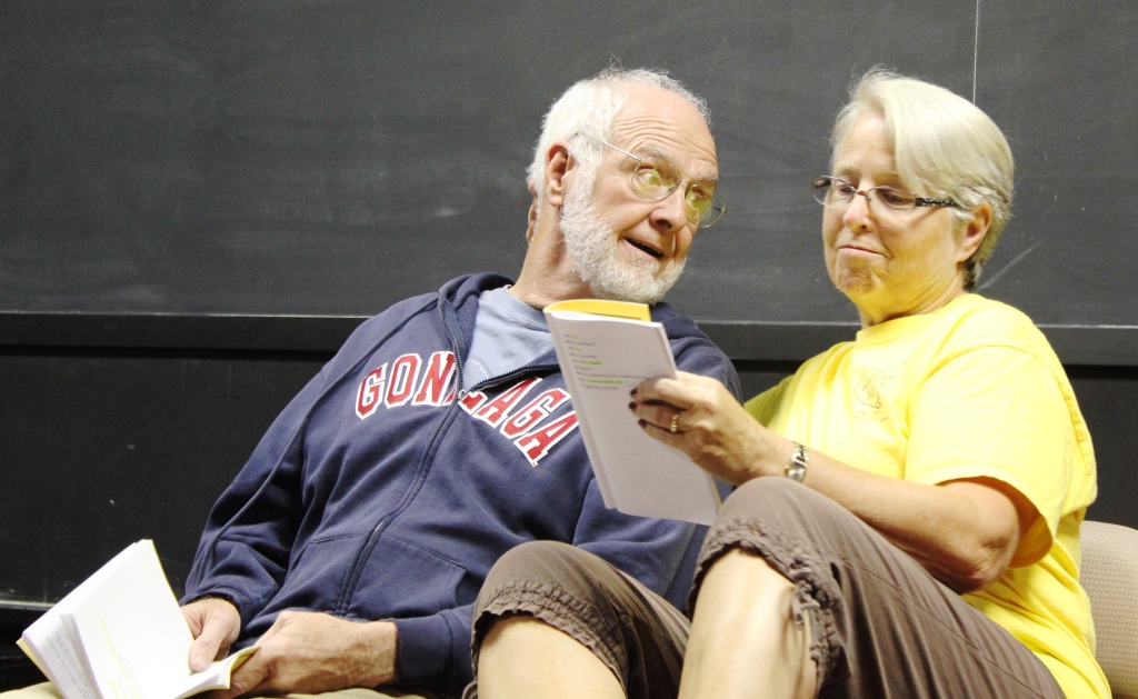 A couple reads onstage