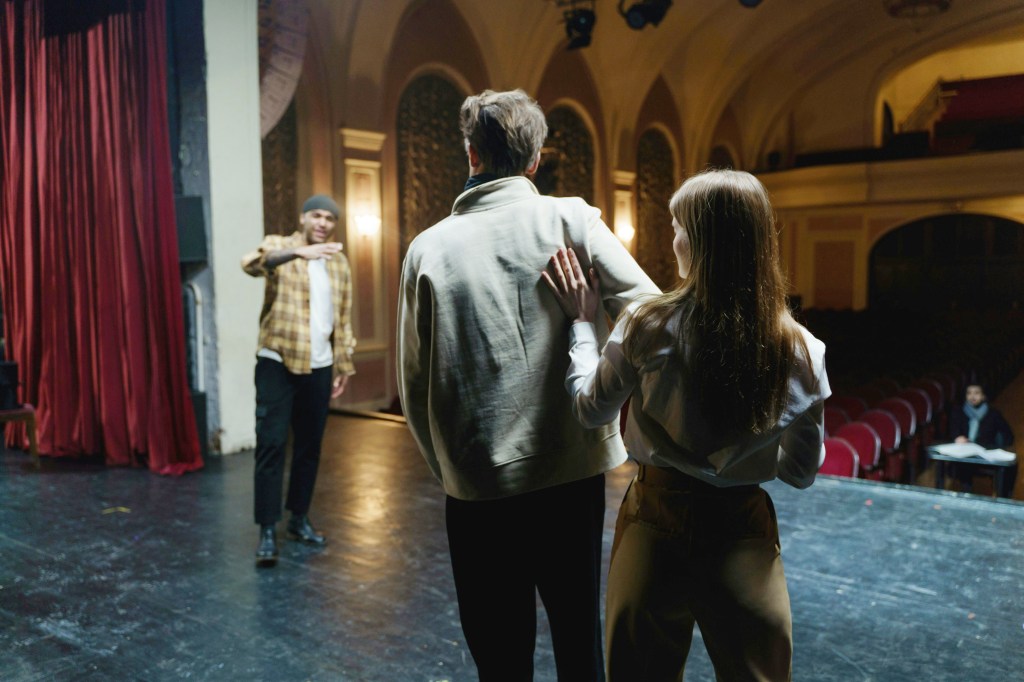 Actors onstage rehearsing